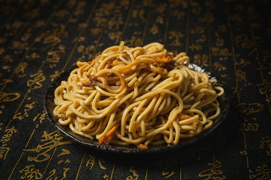 Close-up of Asian noodles on a decorative plate, perfect for food lovers.